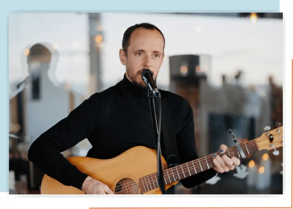 Jasper Hawkins performing acoustic guitar and vocals